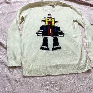 White sweater with robot in front.